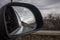 Car roads through the right car mirror when traveling in Europe,.horizontal