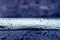 Car roof railing abstract closeup with rain drops