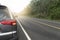 Car running on the asphalt road for travel trip a straight curved path forward.