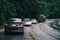 Car in rural road in deep rain forest with green tree forest view from above, rental car in spain mountain landscape road