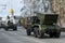 Car of Russian army against background of white chapel. Military equipment drives through the empty streets of city.