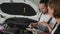 Car`s master shows technical condition Car on tablet, Auto repairman Shows on breakdown vehicle, auto mechanic advises