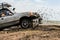 A car`s racing in mud during an off-road racing competition.