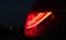 a car's tail light showing the tail lights red