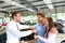 car salesman hands over the car key in the car dealership to customers