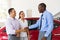 Car salesman handshaking buyer