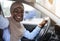 Car Selfie. Cheerful black muslim woman taking self-portrait in her new auto