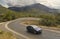 Car on serpentine road in mountains