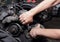 Car service - Engine repair mechanic hands with wrench  generator nut