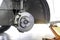 Car service - mechanic unscrewing brake disc of the vehicle for repair