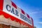 Car Service sign on the curved awning of a commercial brick building