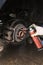 A car service worker with gloves splashes brake discs on a passenger car with grease. Auto to replace the wheels