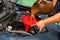 Car servicing mechanic pouring oil to engine