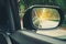 Car side mirrors with natural road travel in warm sunlight