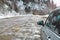 Car on a snowy dirt road in the mountains.