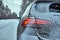 Car on snowy road in forest in winter