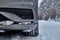 Car on snowy road in forest in winter