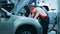 Car specialist checks insides of a car using his flashlight