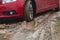 Car stuck in the mud  car wheel in dirty puddle  rough terrain