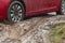 Car stuck in the mud  car wheel in dirty puddle  rough terrain