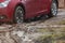 Car stuck in the mud  car wheel in dirty puddle  rough terrain