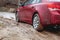 Car stuck in the mud  car wheel in dirty puddle  rough terrain