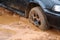 Car stuck in mud after floods caused by storm