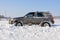 Car stuck in the snow in sunny day