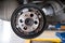 car suspension & bearing of wheel hub in auto service maintenance. Car lift up by hydraulic, waiting for tire replacement in