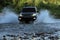 Car SUV overcomes a mountain stream at high speed