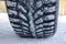 The car tire in the snow close up. Car tracks on the snow. Traces of the car in the snow. Winter tires. Tyres covered with snow at