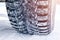 The car tire in the snow close up. Car tracks on the snow. Traces of the car in the snow. Winter tires. Tyres covered with snow at