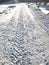 Car tire track on a empty winter snow road