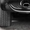 Car tires close-up. Car wheel and exhaust pipe