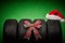 Car tires, new tyres, winter wheels isolated on green background with bow ribbon present