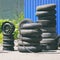 Car tires, rims and tubes next to the tire shop