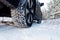 Car tires on winter road covered with snow. Vehicle on snowy way