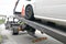 Car towed onto flatbed tow truck with hook and chain