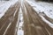 Car tracks on a snowy road. Slippery road, danger, risk of skidding. Traces of winter tire treads