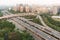 Car traffic on a flyover with residential buildings aerial view