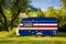 A car trailer, a motor home, painted in the national flag