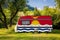 A car trailer, a motor home, painted in the national flag