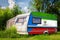 A car trailer, a motor home, painted in the national flag