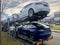 A car transporter carries new Tesla vehicles - mainly Model 3 - near the Munich Delivery Center