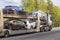 Car transporter transports cars on road