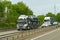 A car transporter transports new cars along a motorway in France, rear view of the trailer.