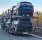 Car transporter truck on semi-trailer on highway