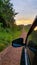 Car travels down a gravel road.