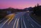 Car and truck lights at sunset on a road in Navarra