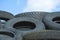 Car Tyres in Recycle Pile against Blue Sky